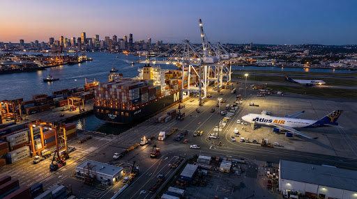 Global EXIM trade logistics, massive container cargo ship and air freight at port terminal